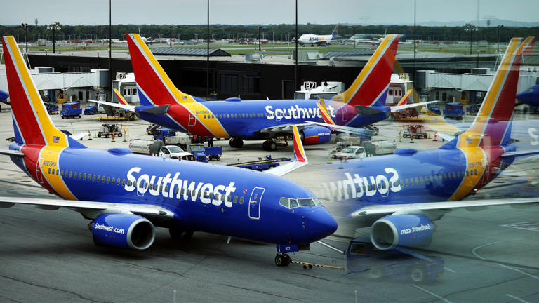 Southwest Airlines aircraft are seen on an airport tarmac. -lead