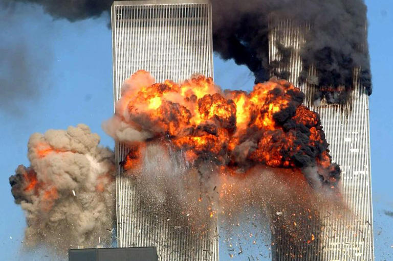 plane smashing into twin towers, fire on top