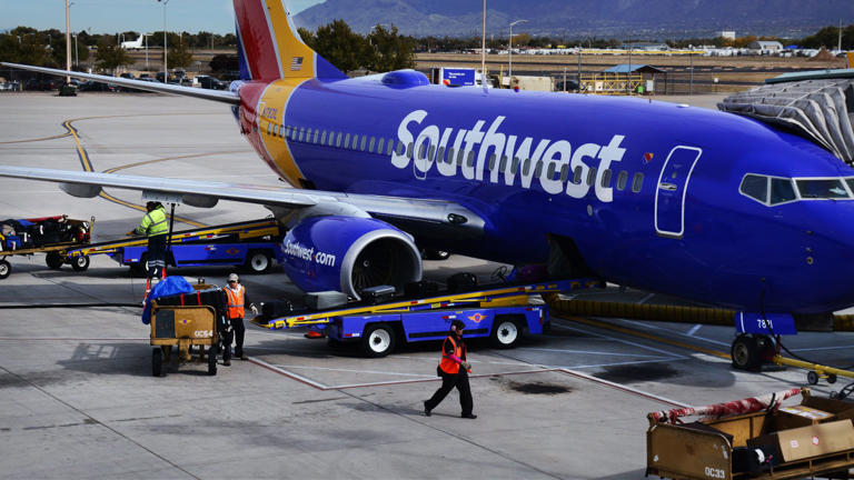 A Southwest Airlines plane is seen at an airport terminal. -lead