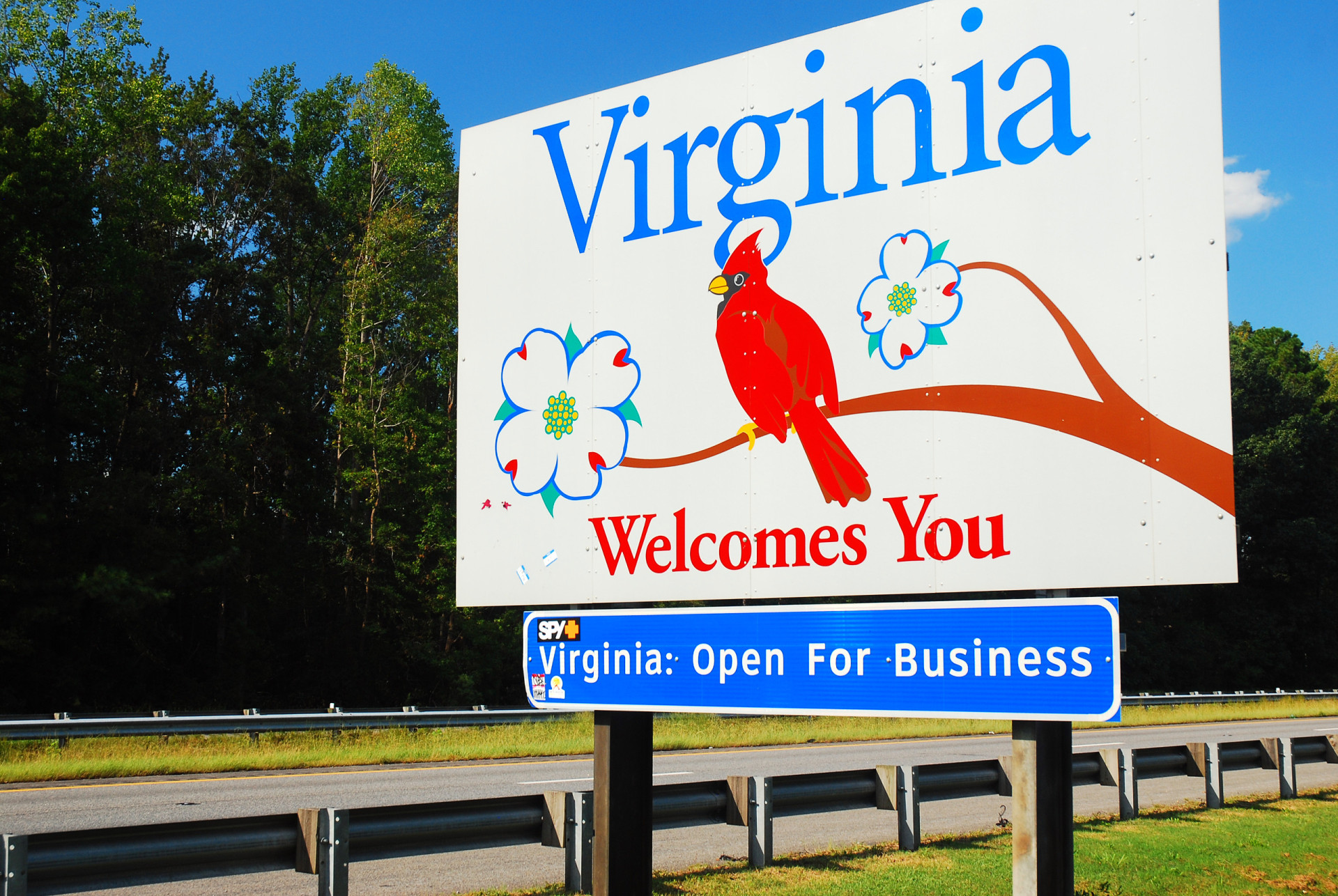 <p>Virginia's welcome sign features both the state's bird and the state's flower, i.e. the cardinal and the American dogwood.</p>