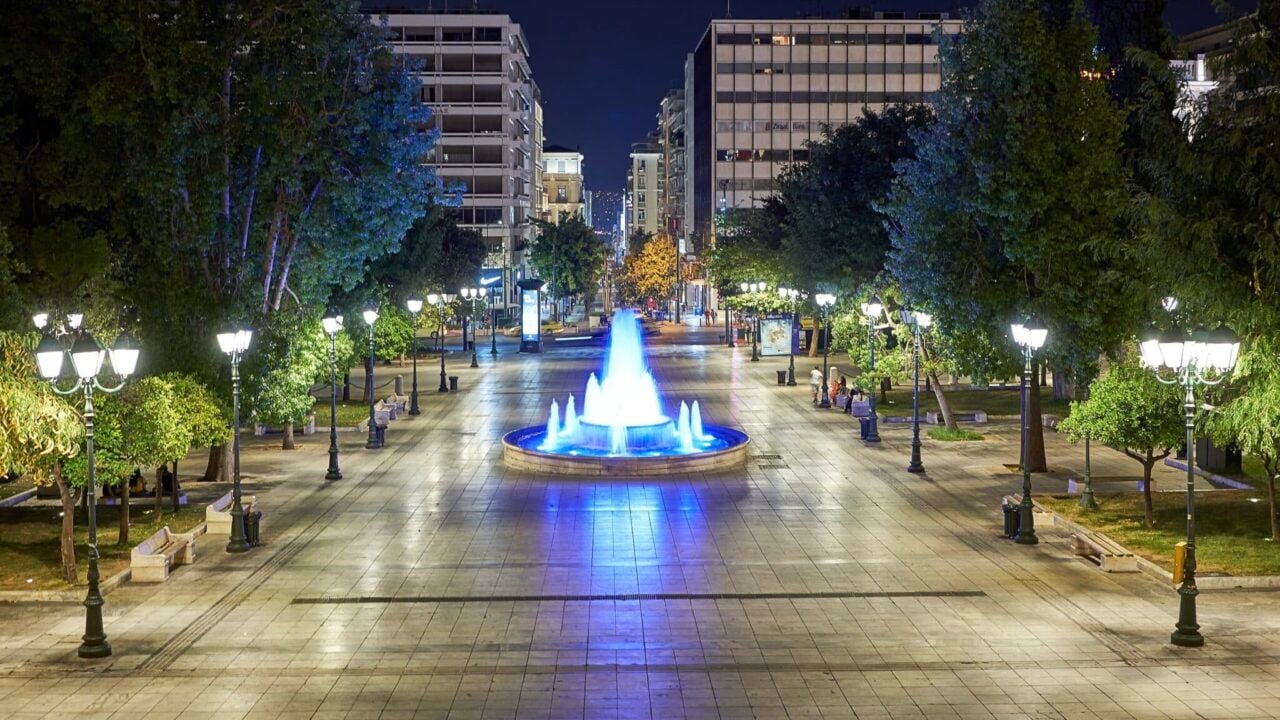 <p>Syntagma Square is the very center of <a href="https://www.visitgreece.gr/mainland/attica/athens/" rel="noopener">Athens</a>. It is a place where all social gatherings and concerts happen. You can see The Old Royal Palace in the Syntagma square, which serves as the Greek Parliament building. Its bright yellow color and neoclassical building style are very distinctive. The building itself was built for King Otto to celebrate Athens becoming the new capital of Greece.</p><p>The square itself was named after the first Greek constitution, and thus the meaning Syntagma Square which in Greek means The Constitution Square.</p>