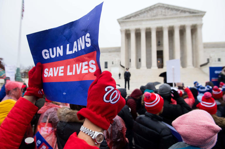 Supporters of gun control and firearm safety measures hold a protest rally outside the Supreme Court as the Court hears oral arguments in State Rifle and Pistol v. City of New York, NY, in Washington, DC, December 2, 2019.
