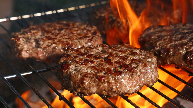 Burgers on hot charcoal grill