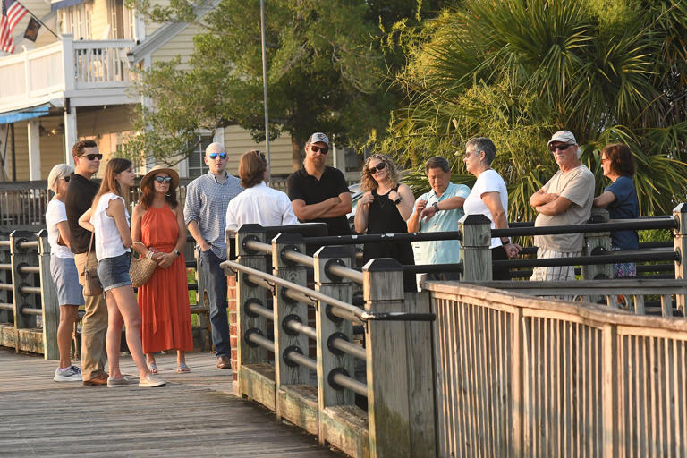 People enjoy a tour along the Riverwalk in downtown Wilmington, N.C. Thursday June 29, 2023. The Riverwalk that is open year round stretches nearly 2 miles along the Cape Fear River from Nunn Street to the Isabella Holmes Bridge. While walking along the river you can find restaurants with spectacular views, markets, art galleries, narrated tours and boat tours. KEN BLEVINS/STARNEWS