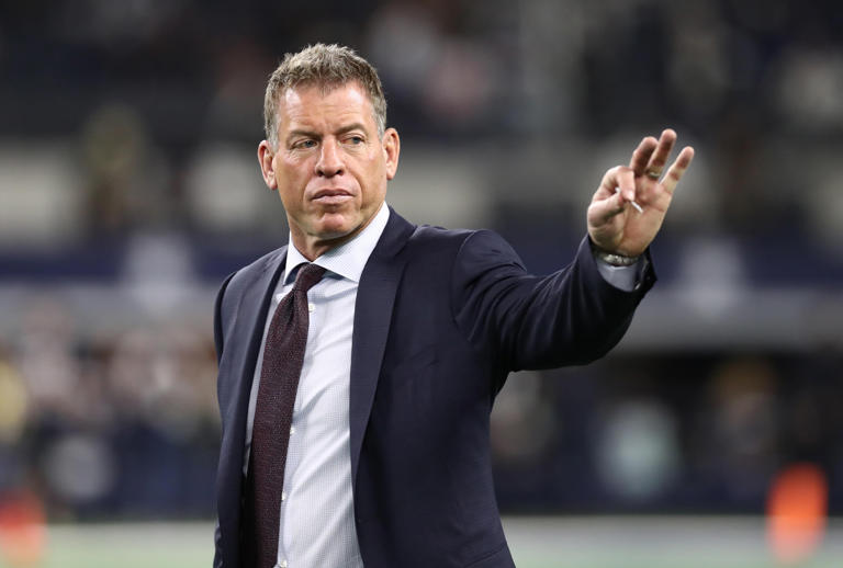 Troy Aikman waves prior to the game with the Dallas Cowboys playing against the New Orleans Saints at AT&T Stadium.