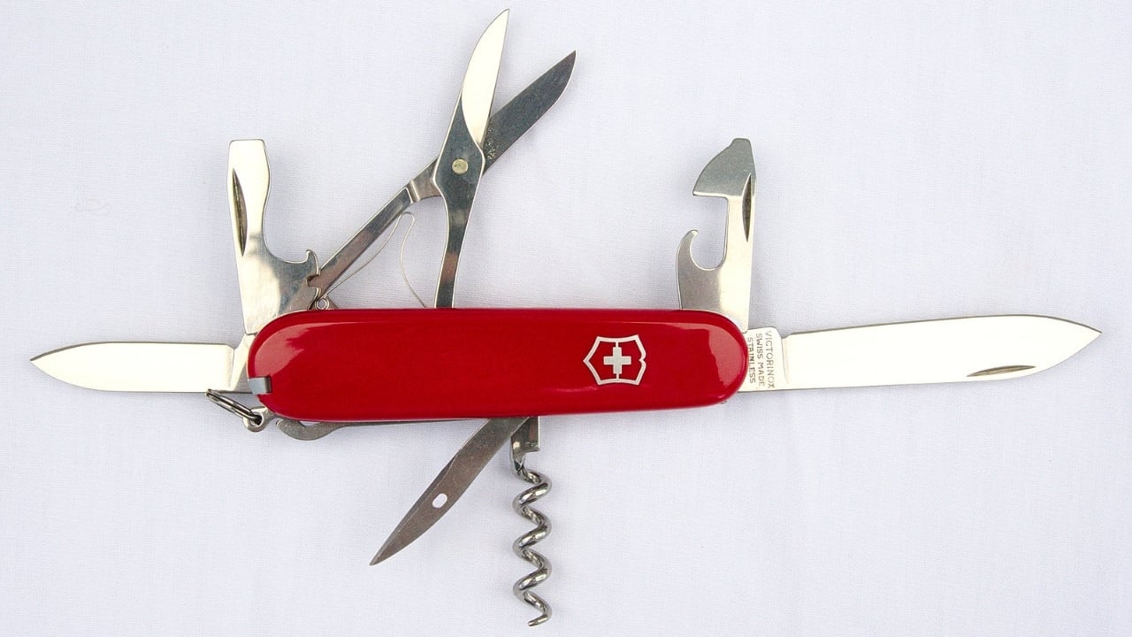 <p>A Swiss Army knife is a multi-tool that has different blades, scissors, screwdrivers, corkscrews, tweezers, etc. It can help you open bottles, cut food, fix things, or even save lives. It’s a flexible tool to have in your pocket. Just remember, if you’re flying, it’s safe to pack it in your checked luggage, but keep it out of your carry-on to comply with airline and security regulations.</p>