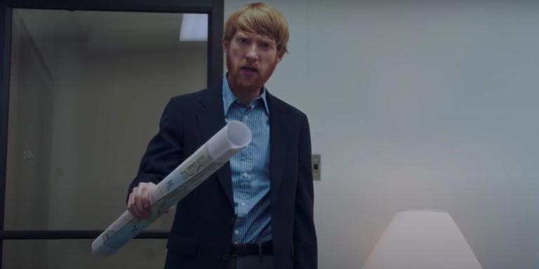 Monty (Domhall Gleeson) holding a map in his hand in American Made