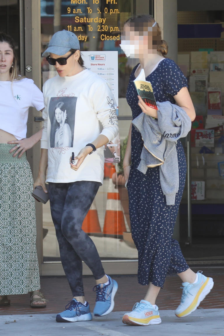 Violet Affleck towers over her mom Jennifer Garner as the duo run errands in Brentwood, California on July 10. Violet wore a blue polka-dot summer dress with sneakers and a white face mask.