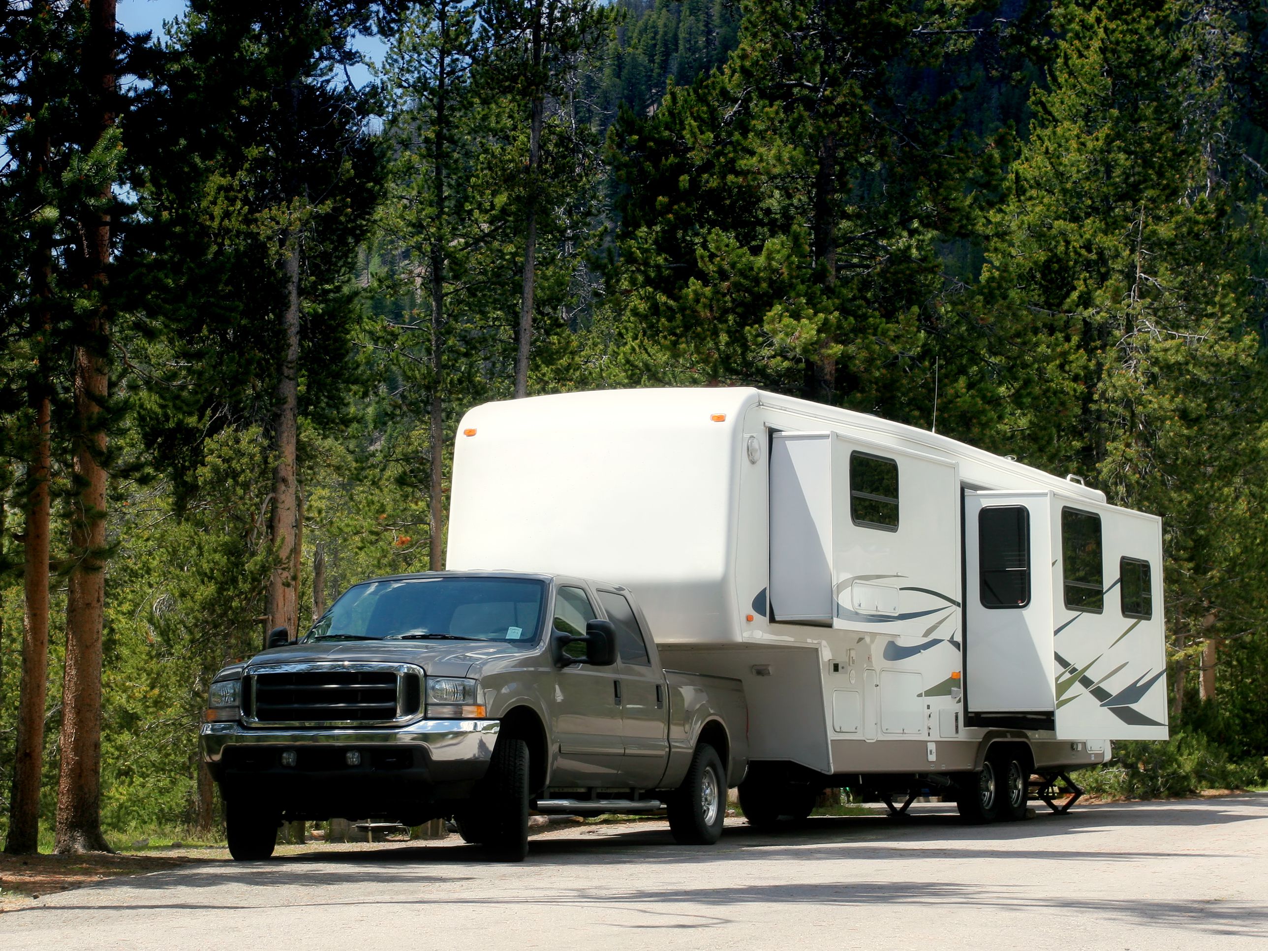 These trailers attach to a special “fifth-wheel” hitch in the bed of the big, powerful trucks that are required to pull them. The biggest trailers you can buy, they get their characteristic look from their raised, forward living/sleeping quarters.