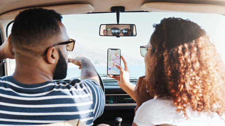 couple in car using navigation app