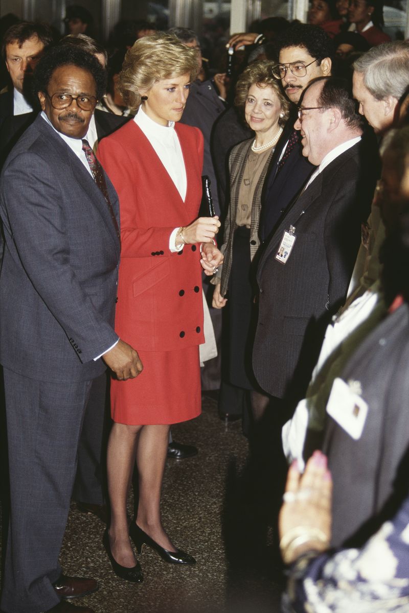 <p>The princess wears a red Catherine Walker skirt suit while visiting the AIDS unit at Harlem Hospital. She <a href="https://apnews.com/article/86aba3240f517c4c63b49674c0555f7c">met several children</a> suffering from the illness before ending her trip to New York. </p>