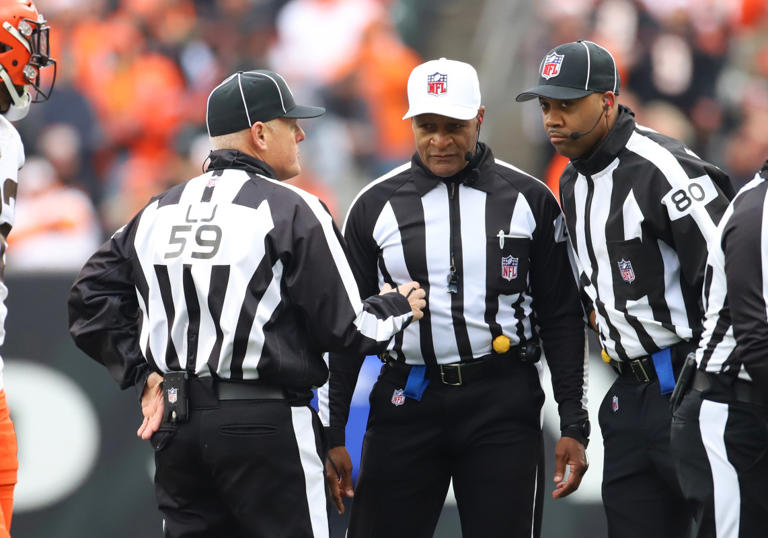 CINCINNATI, OH - DECEMBER 11: NFL officials line judge Rusty Baynes (59), referee Jerome Boger (23), and field judge/side judge Greg Gautreaux (80) discuss a call in a game between the Cleveland Browns and the Cincinnati Bengals on December 11, 2022, at Paycor Stadium in Cincinnati, OH. (Photo by Jeff Moreland/Icon Sportswire via Getty Images) Icon Sportswire/Getty Images