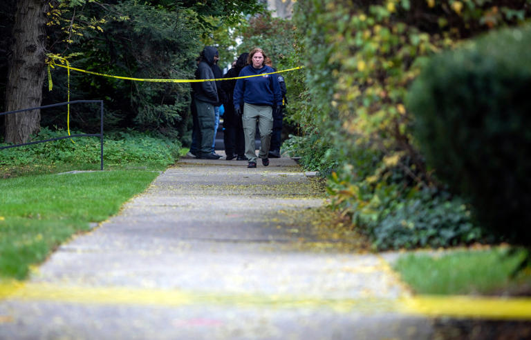 A law enforcement agent walks near the scene near the scene where a Detroit synagogue president, Samantha Woll, was found dead