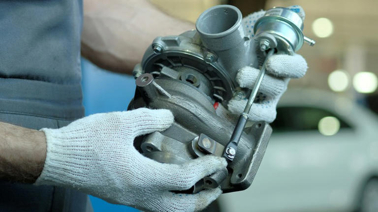 turbocharger in mechanic's hands 