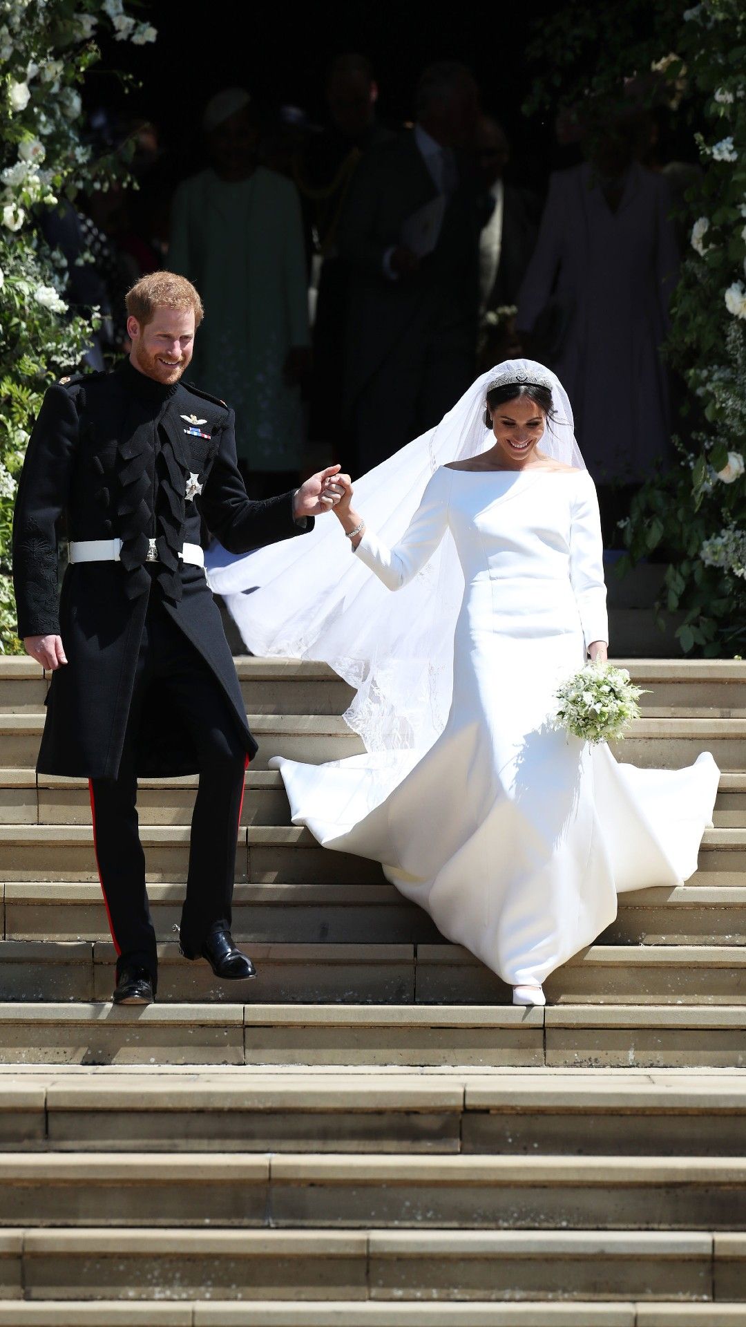 <p>                     Meghan's stunning silk gown was designed by Givenchy artistic director, Clare Waight Keller. The veil was embroidered with flowers representing the countries of the Commonwealth plus the California poppy, a nod to Meghan's home state, and a wintersweet, a flower that grows at Kensington Palace.                   </p>                                      <p>                     The dress was made of silk with three-quarter-length sleeves, an open boat neckline and a train with built-in triple silk organza underskirt.                   </p>