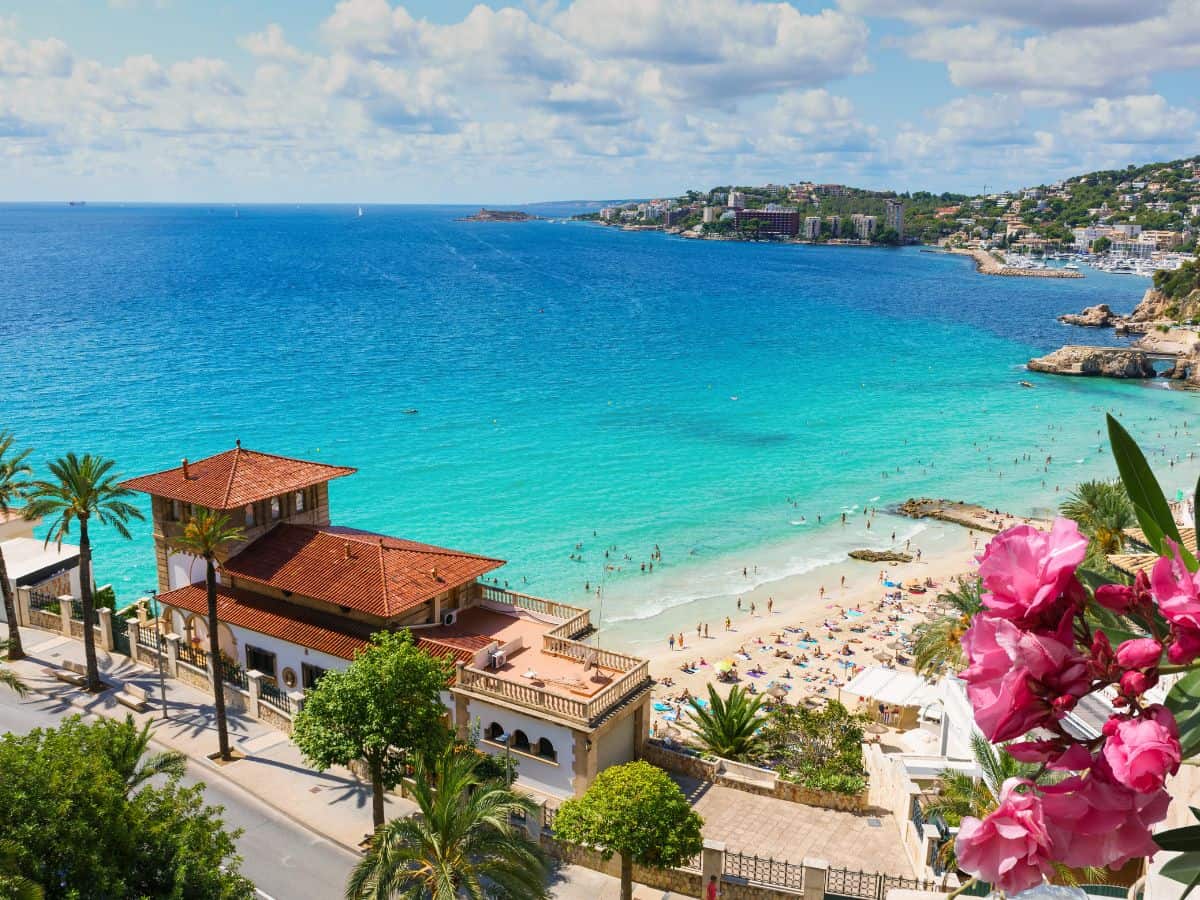 Cala Major Beach in Mallorca, with its golden sands and azure waters, framed by a scenic coastline.
