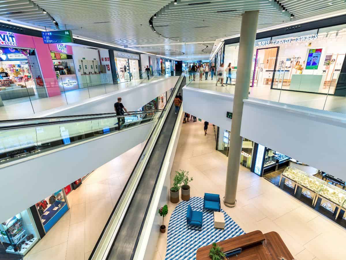 Inside the Porto Pi Shopping Mall in Palma, Mallorca, showcasing a variety of stores and bustling shoppers.