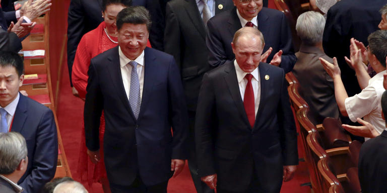 Russia's President Vladimir Putin (front, R), Chinese President Xi Jinping (front, L), his wife Peng Liyuan (2nd row, L), and Chinese Premier Li Keqiang (2nd row, R), arrive for a gala show to mark the 70th anniversary of the end of World War Two, in Beijing, China, Sept. 3, 2015. Reuters/Kim Kyung Hoon