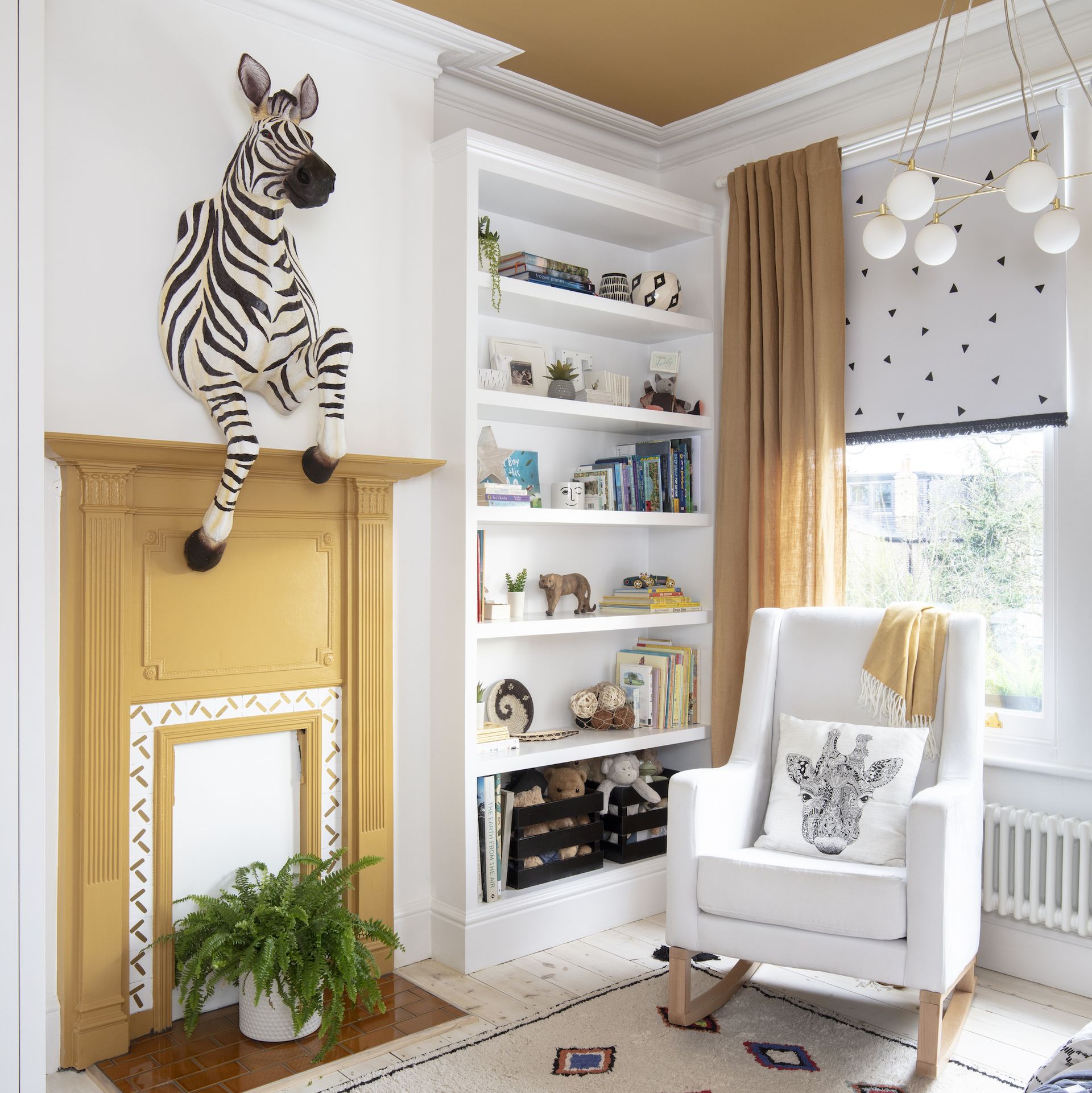 <p>                     It's entirely possible to create a nursery scheme that will suit a tiny tot and appeal to you, the parents.                   </p>                                      <p>                     Against the plain white walls, the mustard yellow on the ceiling, fireplace and curtains in this baby boy's nursery look smart and sophisticated, while the running zebra wall decoration adds a fun touch.                   </p>                                      <p>                     The running zebra wall hanging is a pricey piece but it's possible to find similar cheaper animal decorations.                   </p>