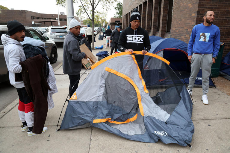 Venezuelan migrants sheltering outside the 11th District Chicago police station in Chicago set up tents that were donated to them on Oct. 11, 2023. Roughly two dozen tents were given out.