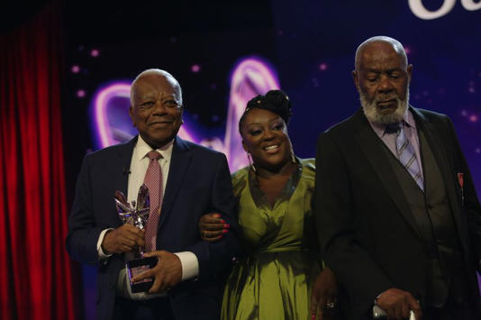 The Windrush Generation (represented by Alford Gardner, Lloyd Coxsone, Joseph Mowlah-Baksh, Guy Bakley and Vernesta Cyril) win Outstanding Contribution Award presented by Sir Trevor McDonald and Judi Love at the 2023 Pride of Britain Awards