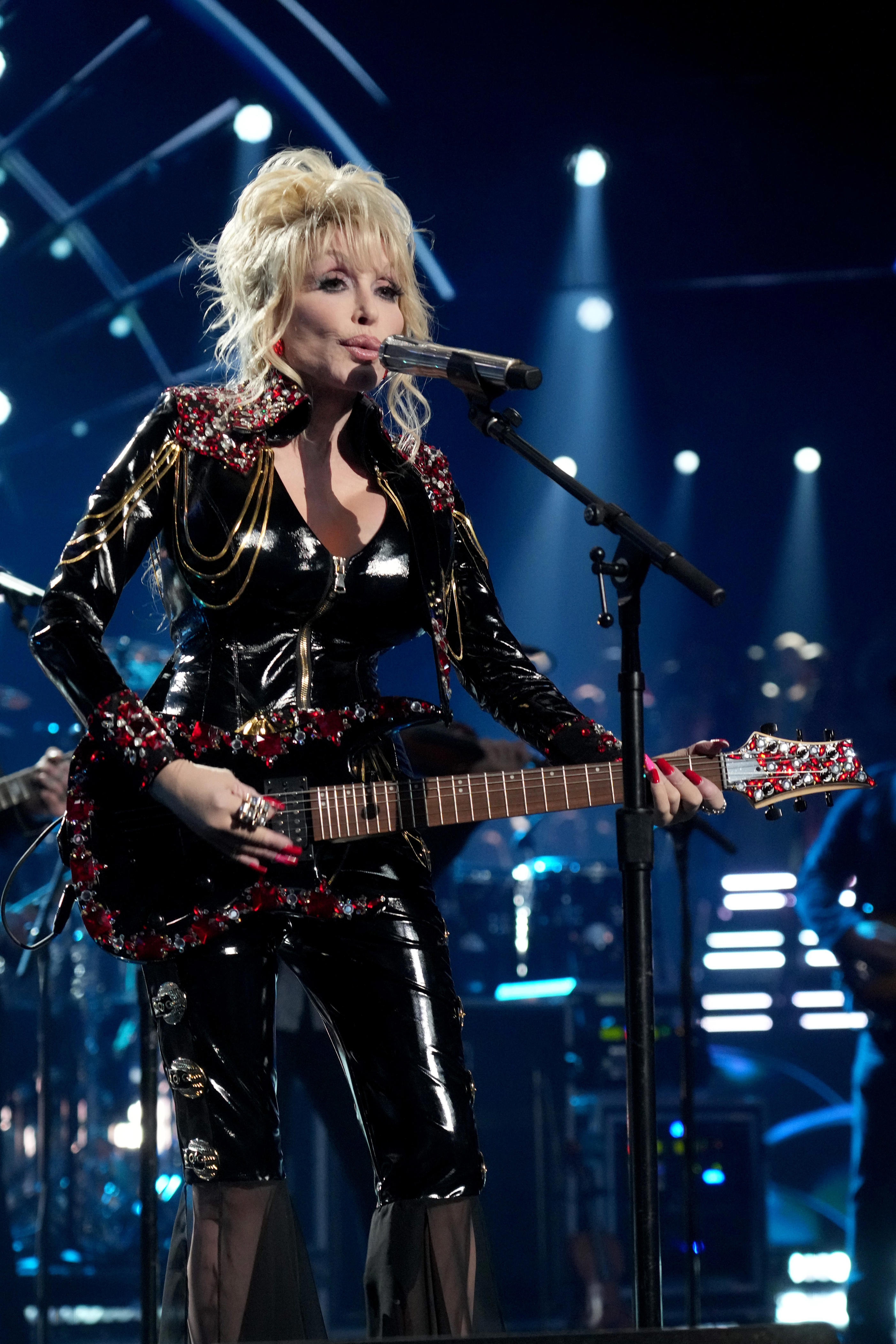 Dolly Parton says jumpsuits became her 'go-to look' on stage because ...