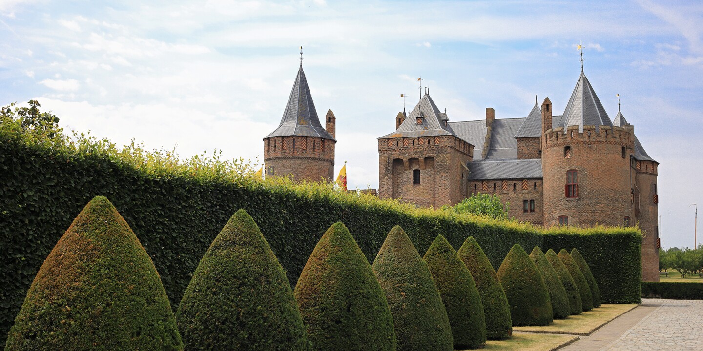 <p>The Netherlands may be better known for its windmills than its castles, but Muiden Castle rivals those in neighboring Germany.</p><p>Photo by Ninetails/Shutterstock</p><p>Whether it’s seeing a Renaissance sculpture or enjoying street food in Singapore, there’s no substitute for being there when it comes to travel. When your agenda includes visiting medieval castles—from the mighty feudal strongholds of <a class="Link" href="https://www.afar.com/travel-guides/tags/scotland/guide" rel="noopener">Scotland</a> to <a class="Link" href="https://www.afar.com/travel-guides/germany/guide" rel="noopener">Germany</a>’s fairy-tale-like creations—imagination helps to conjure up the smells, draftiness, and lack of central heating. At the least, touring one will leave you grateful for the mod cons of 21st-century indoor life.</p><p>An example from Ross Castle in Ireland, which an AFAR editor recently explored: After winding her way up corkscrew staircases, she reached the top floor. It featured the living room or great room of the place. But what captured her attention was down a slim stone hall: The latrine had double-, if not triple-, wide seating. (Alas, photos were not allowed.) That lack of privacy at the privy underscored the communal nature of castle life.</p><p>In some countries, you can hardly throw a stone without hitting a castle. Wales has more than 600 castles (the most per square mile). Many European castles are scenic ruins but plenty have survived intact. They were built to last. So while there is no shortage of castles to explore, some are decidedly more intriguing than others. The following 14 castles illustrate the range of architecture on view. They all were started during the medieval era (aka Middle Ages), which is about 500 to 1450 C.E. Here’s how to visit 14 of most impressive medieval castles in Europe and the United Kingdom.</p><p>Bellver Castle in Spain is a rare circular fortress</p><p>Photo by Shutterstock</p>