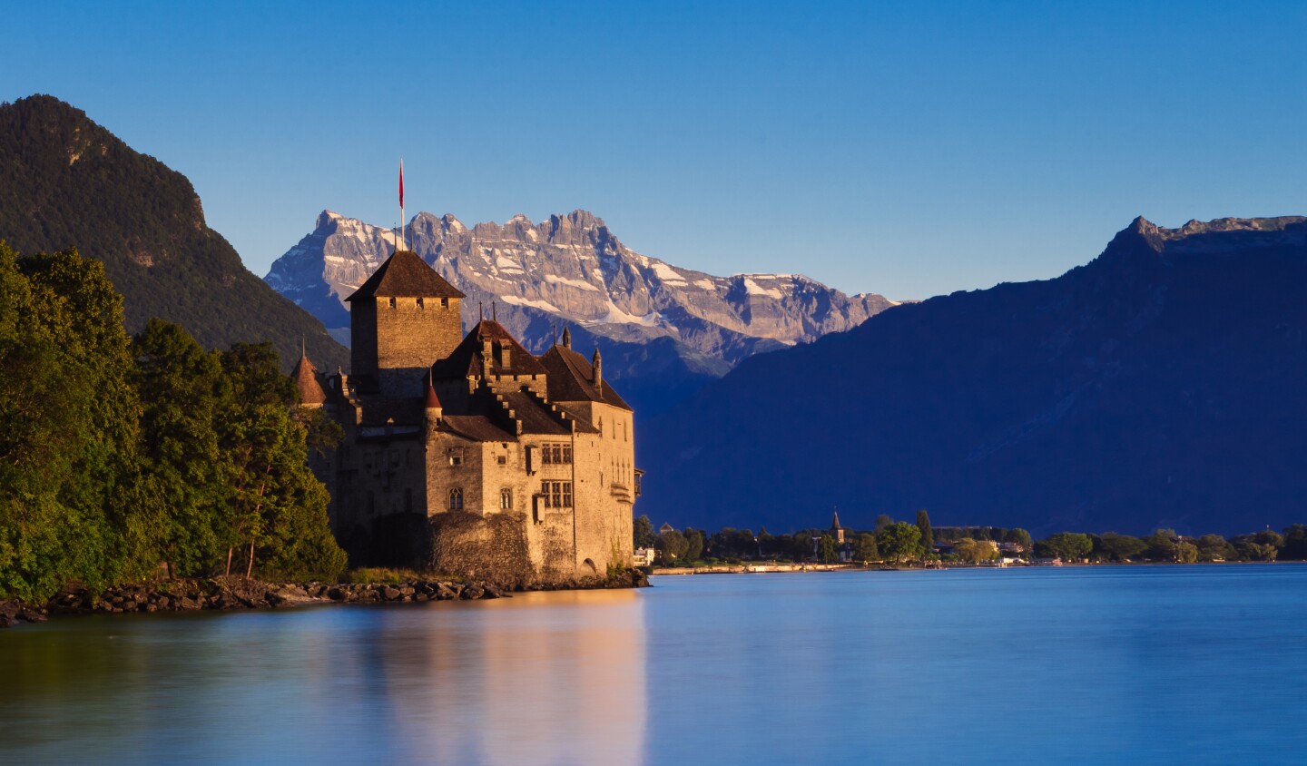 <h2>2. Château de Chillon</h2> <p><i>Veytaux, Switzerland</i></p> <p>Not simply the most popular castle in Switzerland, <a class="Link" href="https://www.chillon.ch/" rel="noopener">Château de Chillon</a> is also the most-visited historic building in the country. Part of that appeal is its location: on an island in Lake Geneva, which acts as a natural moat. Like many castles, additions and occupation continued after the Middle Ages, but the castle got its start in the mid-13th century. Gothic vaults from that time are visible in the prison.</p> <p>And part of the appeal of this castle is its association with Lord Byron. A visit there in 1816 inspired him to write the epic poem “The Prisoner of Chillon.” It’s based on the story of Francois Bonivard, a political prisoner.</p> <h3>How to visit Château de Chillon</h3> <p>Public transport options to the Chillon include a 75-minute train ride from Geneva three times a day and a direct ferry from Lausanne in the morning that takes 90 minutes. By car, the castle is about 2.5 miles from Montreux, and it’s open year round, except for the last week of December. Among several options for guided tours, you can finish with a glass of Clos de Chillon wine.</p>