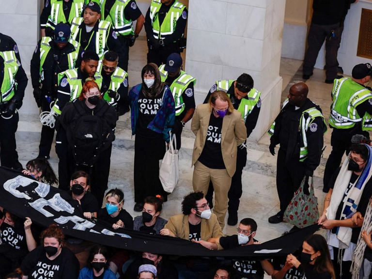 Demonstrators are detained by U.S. Capitol police officers during a protest calling for a cease fire in Gaza while occupying the rotunda of the Cannon House office building on Capitol Hill in Washington, D.C., on Oct. 18, 2023.