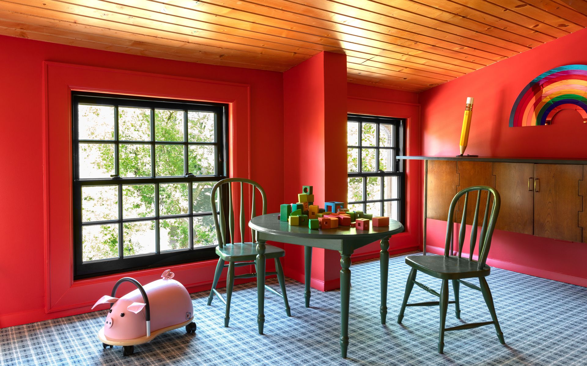 <p>                     The best thing about playroom designs is that you can really go wild with color choices – those combinations you wouldn’t normally use can be set free. Take this fun playroom by M. Lavender Interiors as an example: bright scarlet walls teamed with black window frames, forest green painted furniture and a plaid carpet. Painted surfaces can easily be wiped clean too, or painted over if little hands start drawing on the walls.                   </p>                                      <p>                     Mark Lavender, of M Lavender Interiors, explains the brief for this playroom for two children: ‘The third floor attic space was converted into a playroom for our client’s two children. We took advantage of this dormer area to provide a quiet place for reading or viewing out the window for the parents while their kids were playing in the rest of the space. It also serves as a place of respite from the hustle and bustle of the house if the rest of the family is downstairs.’                   </p>