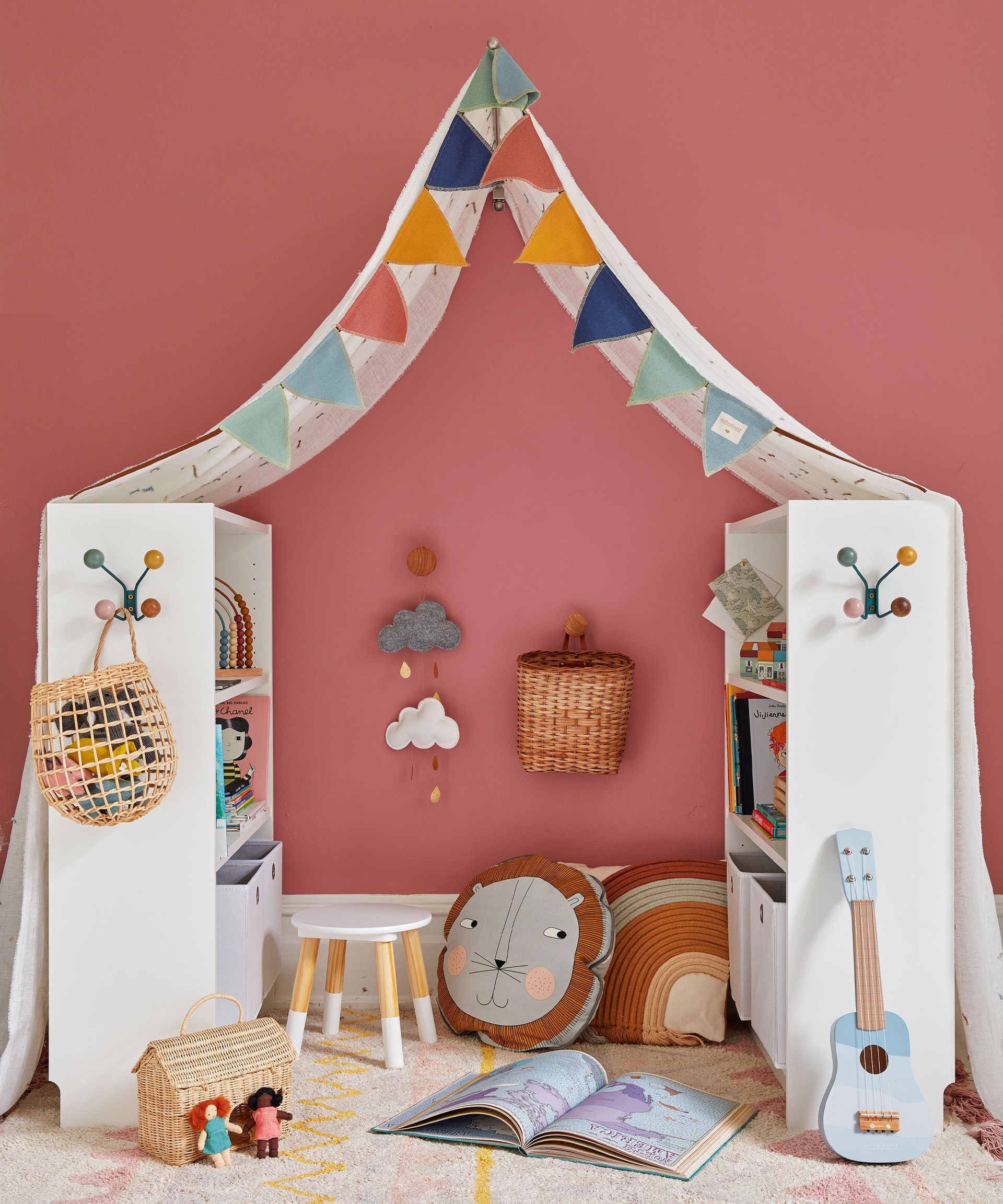 <p>                     'Within a playroom you can create different areas, like this cozy reading nook where your little one can sit surrounded by their favorite books. Use a combination of shelving and cupboard space that will hold a variety of toys and books,' says Melanie Griffiths, editor, <em>Period Living.</em>                   </p>