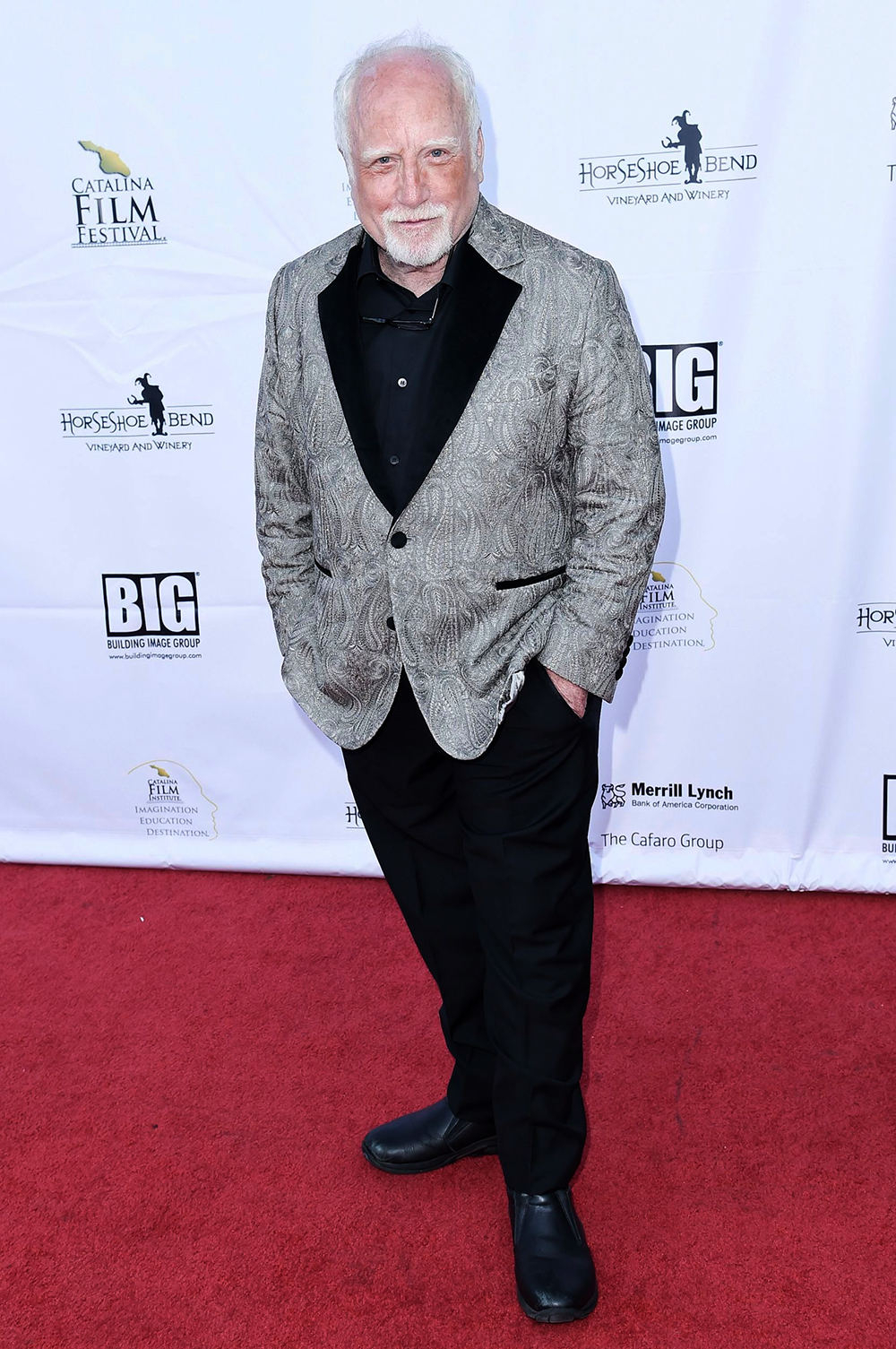 <p>Richard Dreyfuss on the red carpet at the Catalina Film Festival in Sept. 2018. For this event, the actor rocked a paisley-patterned grey suit, a black shirt, and black trousers. He completed the look with black dress shoes and rocked some silver locks.</p>