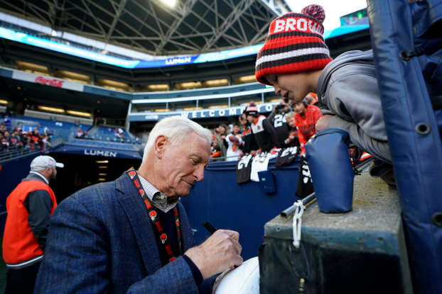 Jimmy Haslam, managing and principal partner of the Cleveland Browns, signs an autograph before an NFL football game against the Seattle Seahawks, Sunday, Oct. 29, 2023, in Seattle. (AP Photo/Lindsey Wasson)