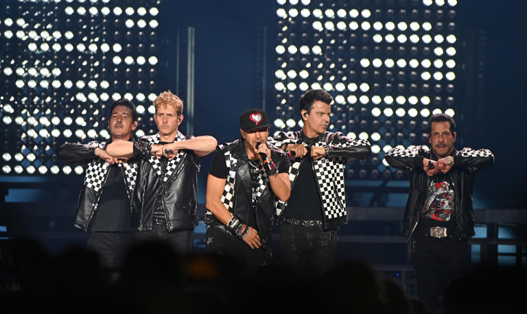 ATLANTA, GEORGIA – JULY 07:  Jonathan Knight, Joey McIntyre, Donnie Wahlberg, Jordan Knight and Danny Wood of New Kids On The Block perform onstage during “The Mixtape” tour at State Farm Arena on July 07, 2022 in Atlanta, Georgia. (Photo by Paras Griffin/Getty Images)
