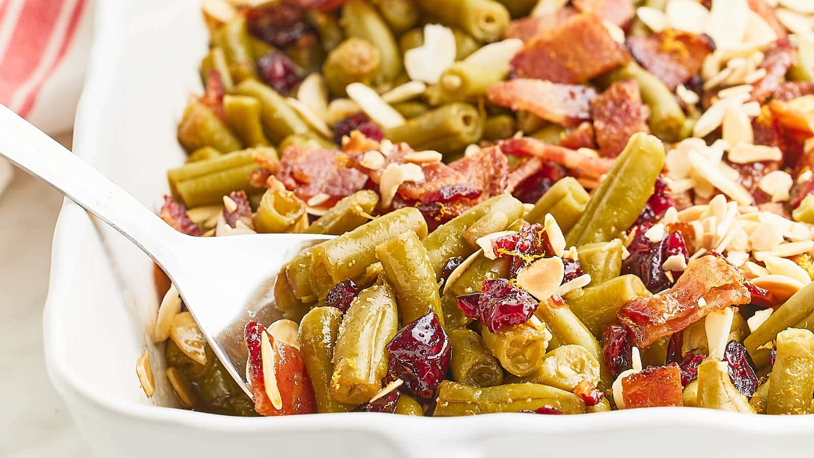 <p>Our Crack Green Beans recipe is a delicious twist on a traditional green bean casserole. And it's incredibly easy to make. We combine canned green beans, cranberries, and crispy bacon, toss it in a sweet and savory sauce, and finish it with sliced almonds.</p><p><strong>Get the Recipe: <a href="https://cheerfulcook.com/crack-green-beans/" rel="noreferrer noopener">Holiday Crack Green Beans</a></strong></p>