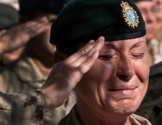 A tearful Sgt. Renay Groves salutes during the final Remembrance Day ceremony at Kandahar Air Field. (Ryan Remiorz/Canadian Press)
