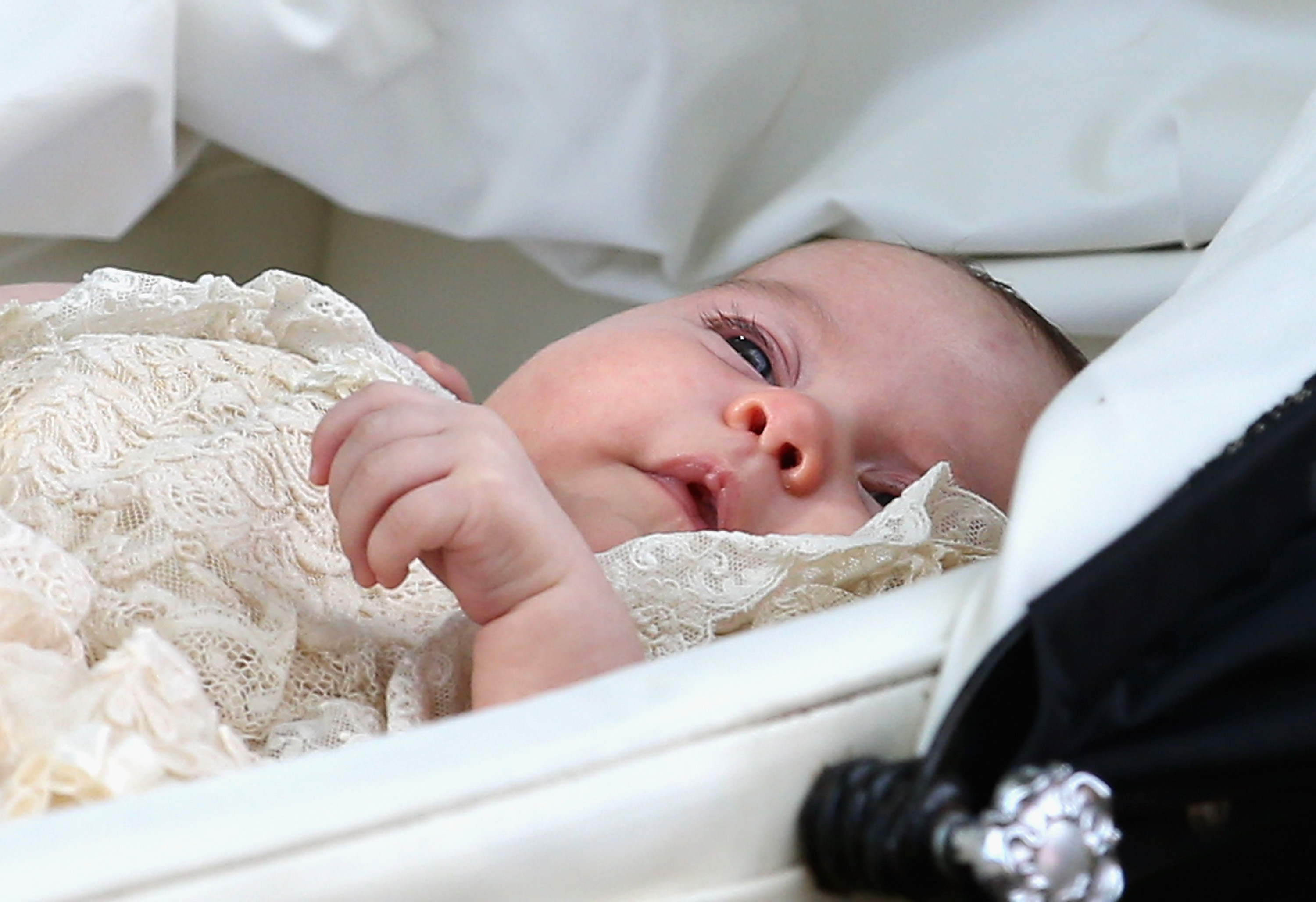 <p>Photographers got a peek at Princess Charlotte's pretty little face as she was pushed in her Silver Cross pram on her christening day, July 5, 2015.</p>