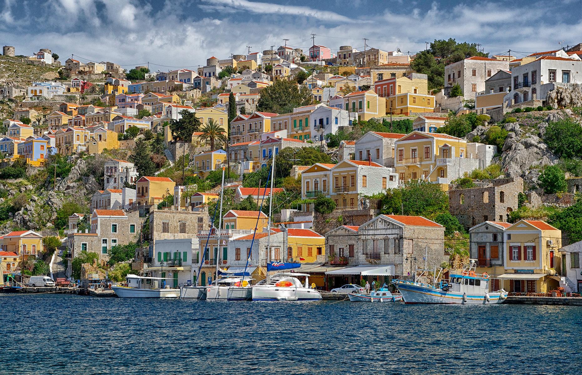 <p>It’s hard to choose among Greece’s 227 inhabited islands, but if you have to pick one, go for Symi. This small Dodecanese island has one of the prettiest ports, a riot of colorful houses tumbling to the water’s edge – not to mention excellent beaches. On the days when it's too hot to hike to the beach, just take a water taxi from Symi harbor.</p>  <p><strong><a href="https://www.loveexploring.com/galleries/184438/greeces-most-beautiful-small-towns-and-villages">Explore more of Greece's most gorgeous places</a></strong></p>