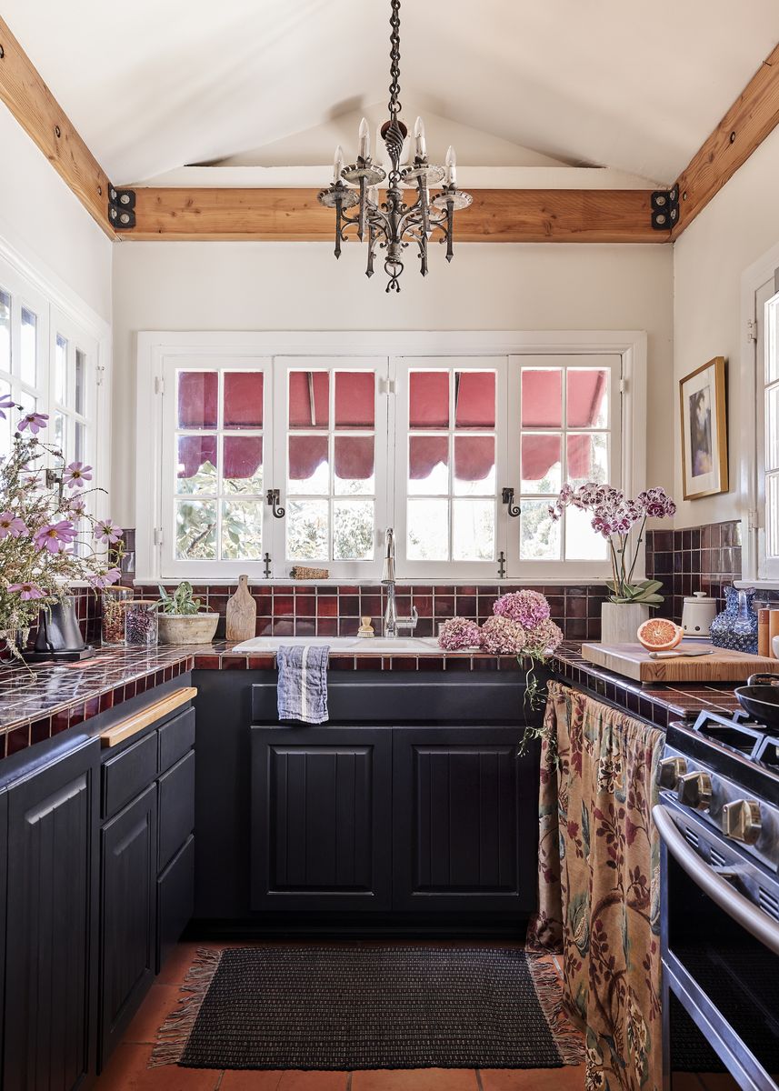 <p>With an open and airy feel, the kitchen was retrofitted to have vaulted ceilings, which Law says make the space feel “quite grand.” Chandelier, <a href="https://www.lahardware.com/">Liz’s Antique Hardware</a>.</p>