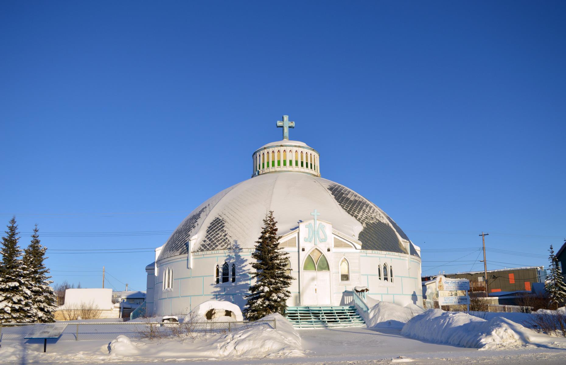 <p>Located well north of the Arctic Circle, it makes sense that the local Catholic church in Inuvik is designed to mimic the shape and look of a snow-covered igloo. Officially known as Our Lady of Victory, the striking exterior of Inuvik’s unique 'igloo church' offers one of the best photo opportunities in this northern community. Tours of the interior are also available during the summer months.</p>