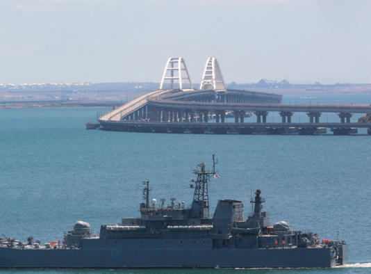 A picture taken on July 17, 2023 shows a Russian warship sailing near the Kerch bridge, linking the Russian mainland to Crimea, following an attack claimed by Ukrainian forces. Ukraine claimed another strike on Crimea on November 10, 2023, in which two Russian landing boats were reportedly destroyed