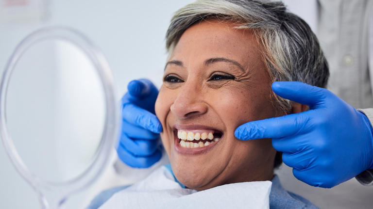 Older woman smiling after teeth cleaning