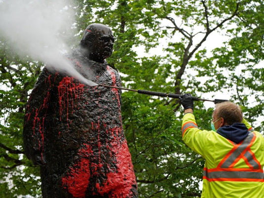 The statue of Sir Winston Churchill in Edmonton is washed after it was vandalized in 2021.