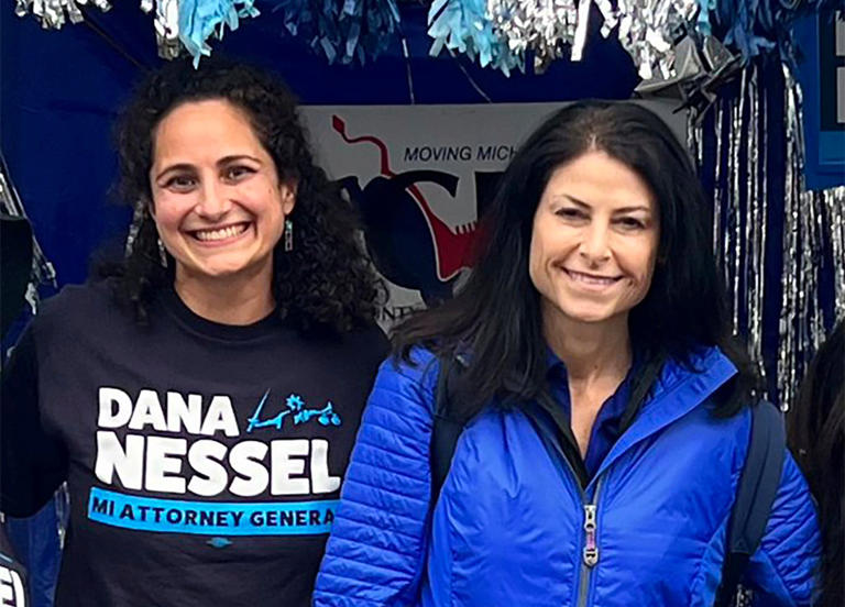 In this photo released by Kimberly Bush, Samantha Woll, left, poses with Michigan Attorney General Dana Nessel on 4 September, 2022 (Kimberly Bush)