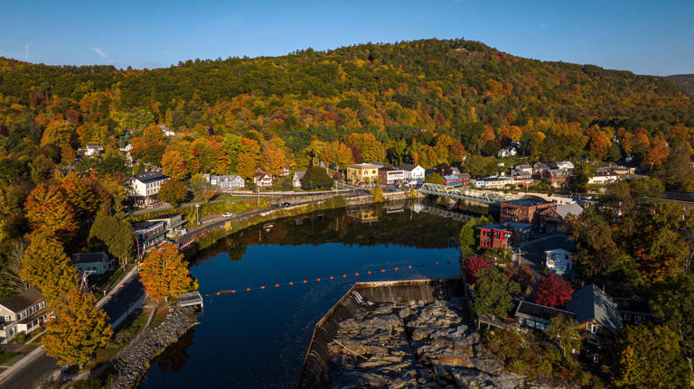 The sun rises over Sheffield Falls, Mass., unveiling the autumn splendor with the Housatonic River meandering through the quaint town embraced by the Berkshire mountains. Visions of America/Joseph Sohm/Universal Images Group via Getty Images