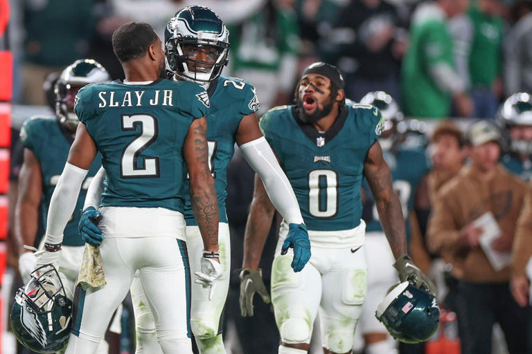 Eagles cornerback James Bradberry celebrates with Darius Slay after stopping Dallas Cowboys wide receiver CeeDee Lamb on fourth down.