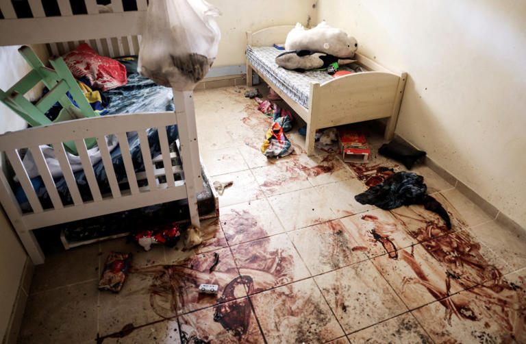 Children's toys and personal items lie on the bloodstained floor of a child's bedroom, following a deadly infiltration by Hamas gunmen from the Gaza Strip, in Kibbutz Beeri in southern Israel October 17, 2023. (credit: RONEN ZVULUN/REUTERS)