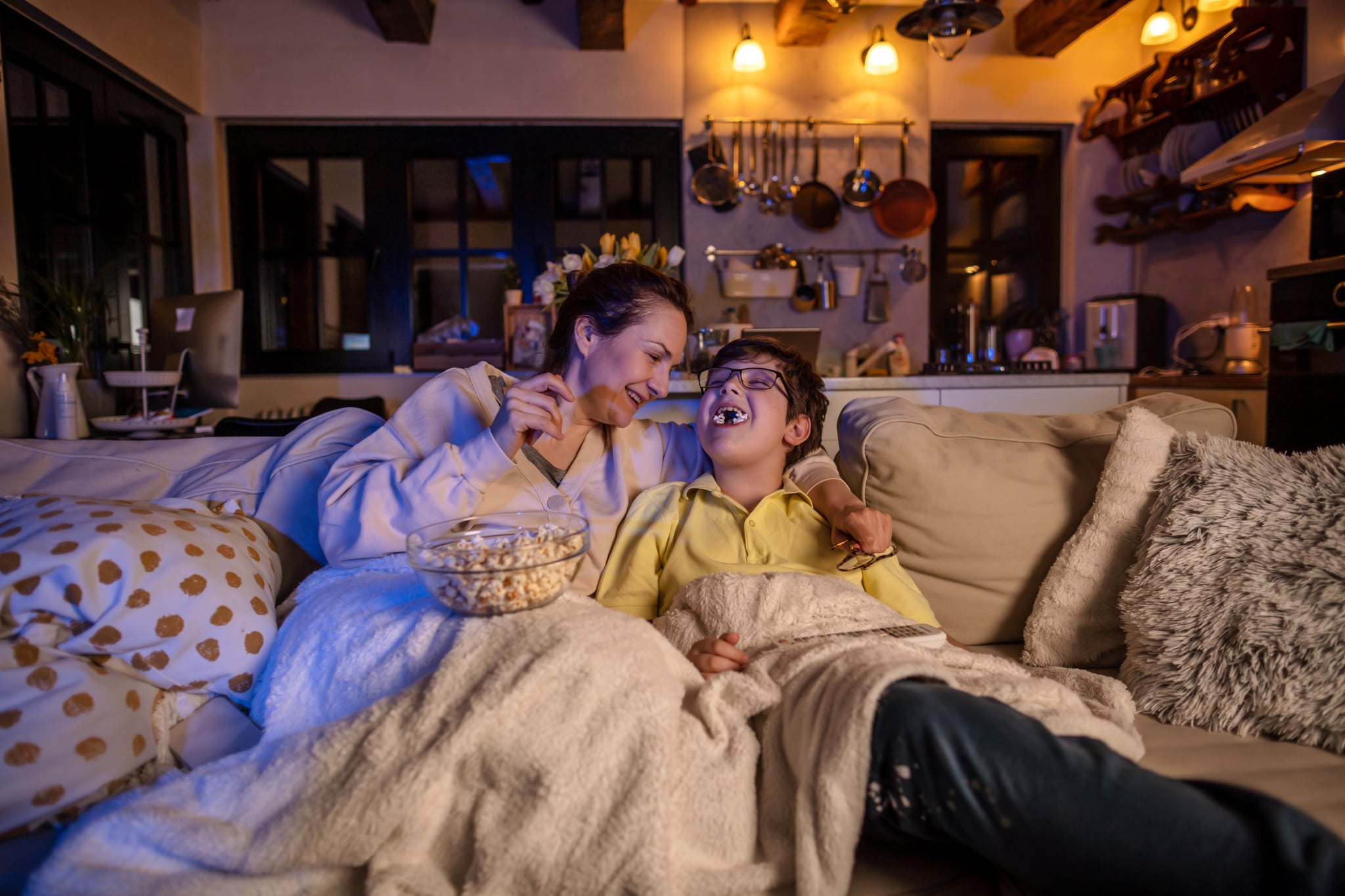 <p>Curling up on the couch and <a href="https://www.popsugar.com/family/feel-good-movies-for-kids-47307583" class="ga-track">watching a favorite flick</a> can keep families warm and snuggly as they pass the time. Draw numbers to see who gets to pick the first movie (and beyond, if you're embracing the "marathon" feature of this idea). Depending on the age of the child, families can also make popcorn and gather together their favorite treats to enjoy during the movie.</p>