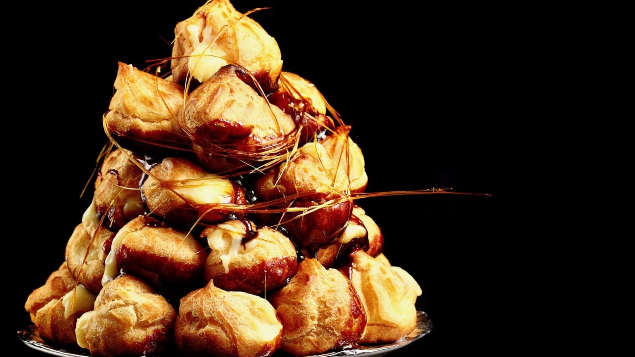 <p>On the other hand, this one is a lot of work but worth it. A croquembouche is a tower of cream puffs glued together with sticky sugar. Make the choux pastry black with cocoa powder and use the sticky sugar to make ghostly designs on the outside for a CroquemBOOche.</p>