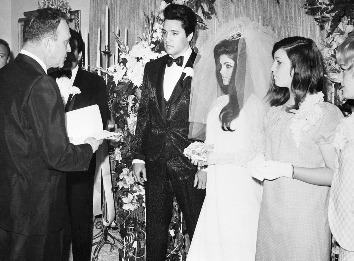 <p>Elvis's tux, designed with paisley silk brocade, was made by MGM Studios's <a href="https://www.vogue.co.uk/fashion/article/priscilla-presley-wedding-dress">Lambert Marks</a>. The famous tailor had dressed the singer for his roles in <em>Girl Happy</em> and <em>Spinout.</em></p>